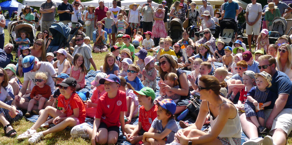 Crowds gather for Paul Jackson's Punch and Judy Show at a London fair